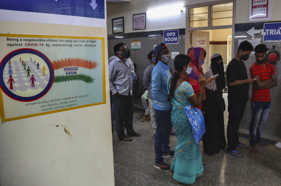 People wait in a queue to register their names to get tested for COVID-19 in Hyderabad, India, Thursday, April 29, 2021. (AP Photo/Mahesh Kumar A.)