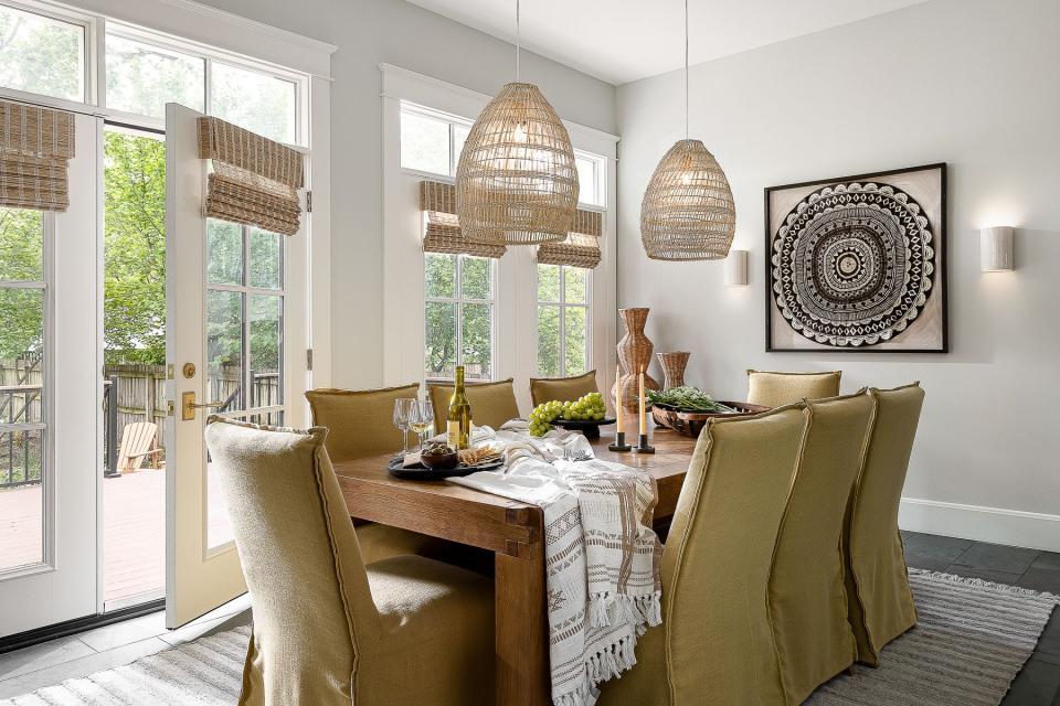 Slipcovers on the dining chairs allow for easy cleanup at this renovated American Foursquare Craftsman home in Old Louisville