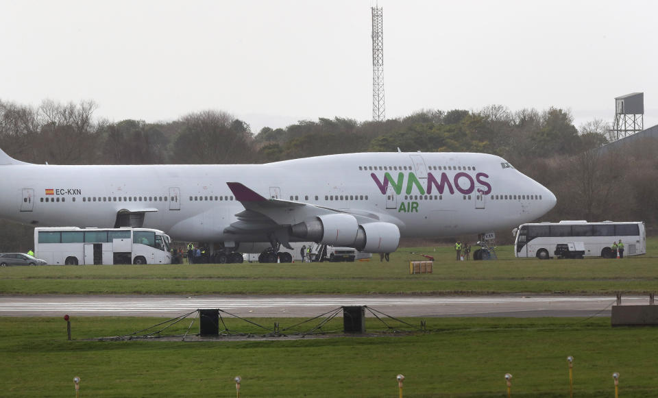 People leave a plane to board a coach at MoD Boscombe Down in Wiltshire after being repatriated to the UK from a cruise ship hit by the coronavirus in Yokohama, Japan.