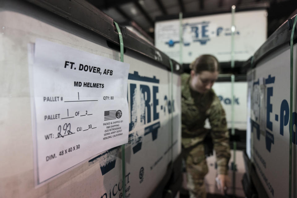 U.S. Air Force Airman Megan Konsmo, from Tacoma, Wash., checks pallets of helmets ultimately bound for Ukraine in the Super Port of the 436th Aerial Port Squadron, Friday, April 29, 2022, at Dover Air Force Base, Del. President Joe Biden asked Congress on Thursday for $33 billion to bolster Ukraine's fight against Russia, signaling a burgeoning and long-haul American commitment. (AP Photo/Alex Brandon)