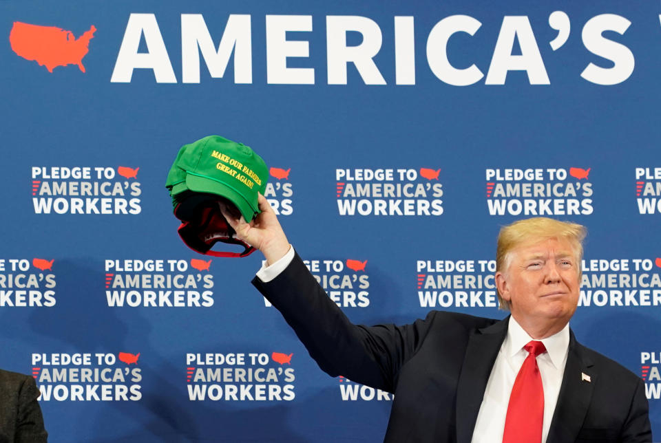 REFILE CORRECTING WORDING ON HAT U.S. President Donald Trump holds up a "Make Our Farmers Great Again" cap during a roundtable discussion on workforce development at Northeast Iowa Community College in Peosta, Iowa, U.S., July 26, 2018. REUTERS/Joshua Roberts      TPX IMAGES OF THE DAY