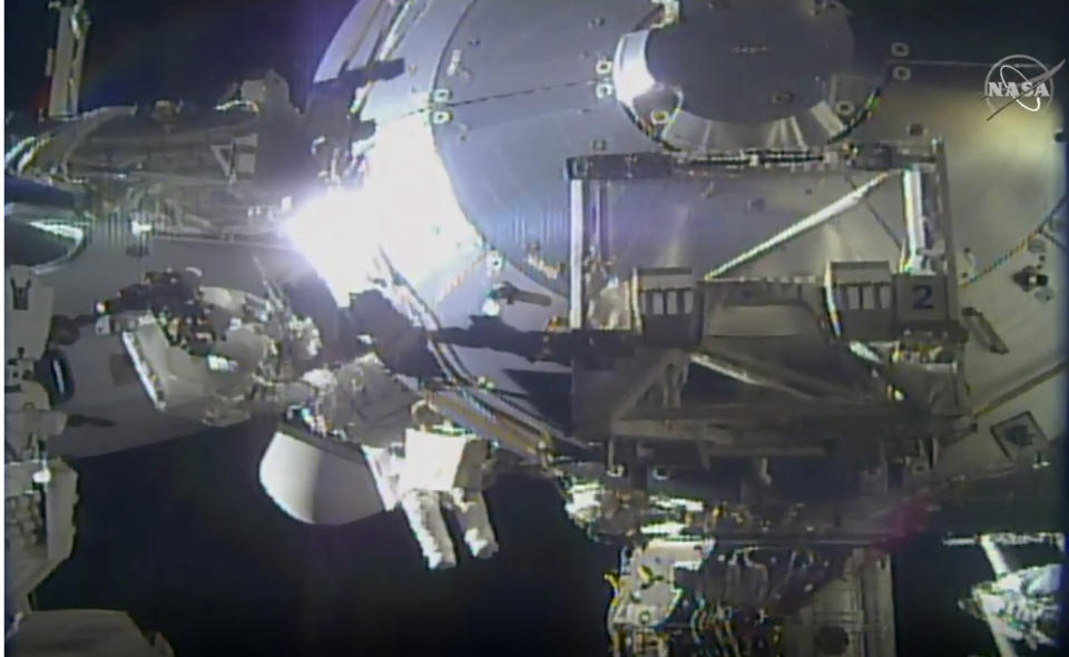 In this image taken from NASA video, NASA astronauts Victor Glover and Mike Hopkins make routine maintenance on the International Space Station’s European lab on Wednesday, Jan. 27, 2021. Glover and Hopkins went spacewalking Wednesday to install a high-speed data link outside the International Space Station’s European lab and connect cables for an experiment platform awaiting activation for almost a year. (NASA via AP)