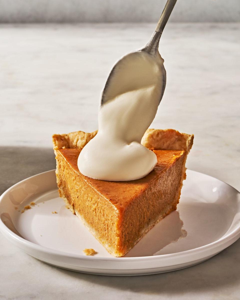 sweet potato pie slice with whipped cream dolloped on