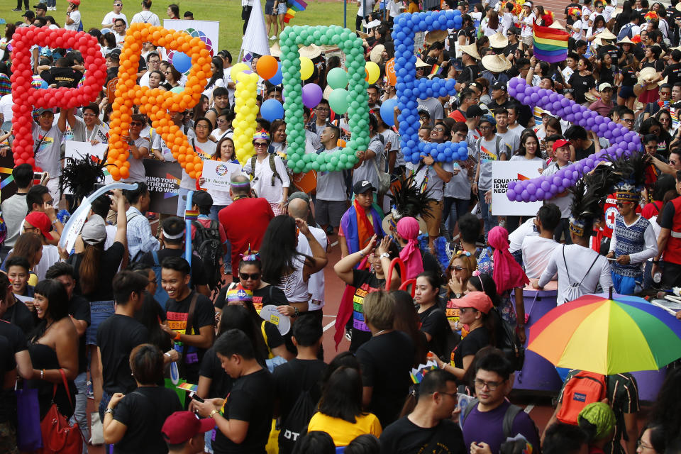 FILE - Thousands of Philippine LGBTQ groups gather at Marikina Sports Complex in the annual celebration of "Pride March" Saturday, June 30, 2018, in Marikina city, east of Manila, Philippines. Singapore’s announcement Sunday, Aug. 22, 2022, that it would decriminalize sex between men is being hailed as a step in the right direction for LGBTQ rights in the Asia-Pacific region, a vast area of nearly 5 billion people with different laws and attitudes. (AP Photo/Bullit Marquez, File)