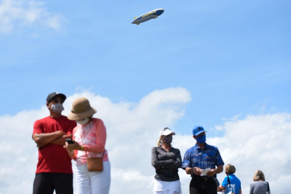 A Goodyear blimp flies overhead fans during the third round of the Honda Classic at the PGA National Resort & Spa in Palm Beach Gardens, FL, on Saturday, March 20, 2021.