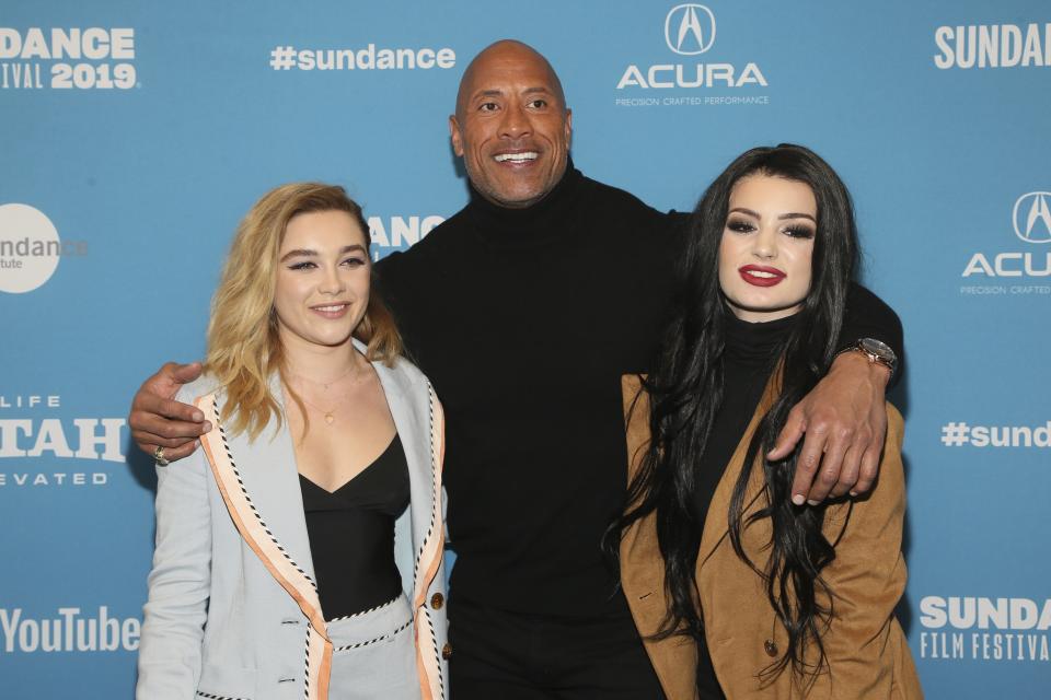 From left to right, cast members Florence Pugh, producer and cast member Dwayne Johnson, and WWE's Paige pose at the premiere of the film "Fighting With My Family" during the 2019 Sundance Film Festival, Monday, Jan. 28, 2019, in Park City, Utah. (Photo by Danny Moloshok/Invision/AP)