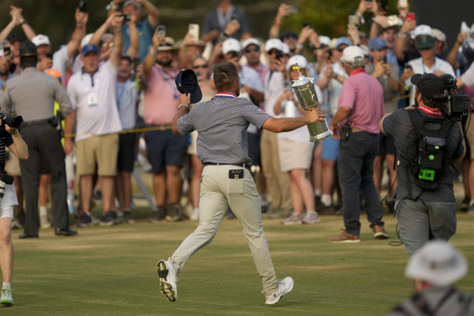 Bryson DeChambeau celebrates with the trophy after winning the U.S. Open golf tournament Sunday, June 16, 2024, in Pinehurst, N.C. (AP Photo/Matt York)