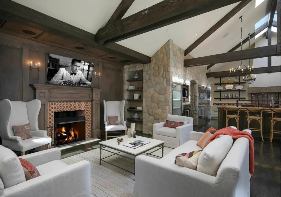 The formal living with a woodburning fireplace that leads to the kitchen. Village Properties