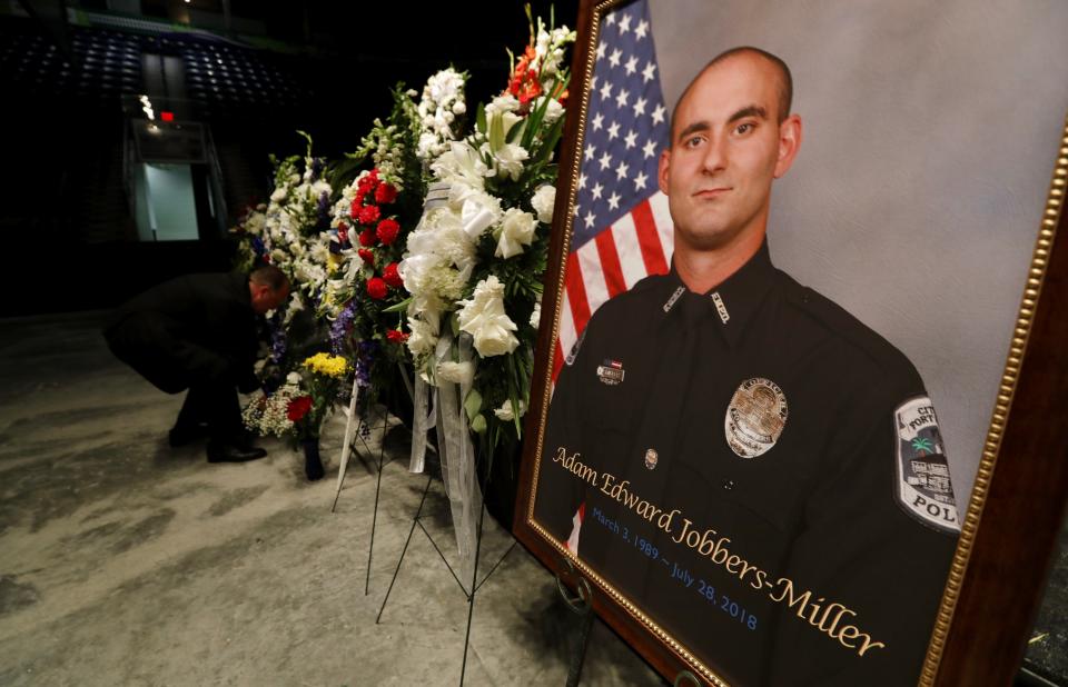 Flowers are being arranged in preparation for the funeral services of fallen FMPD officer Adam Edward Jobbers-Miller Monday morning at Germain Arena.