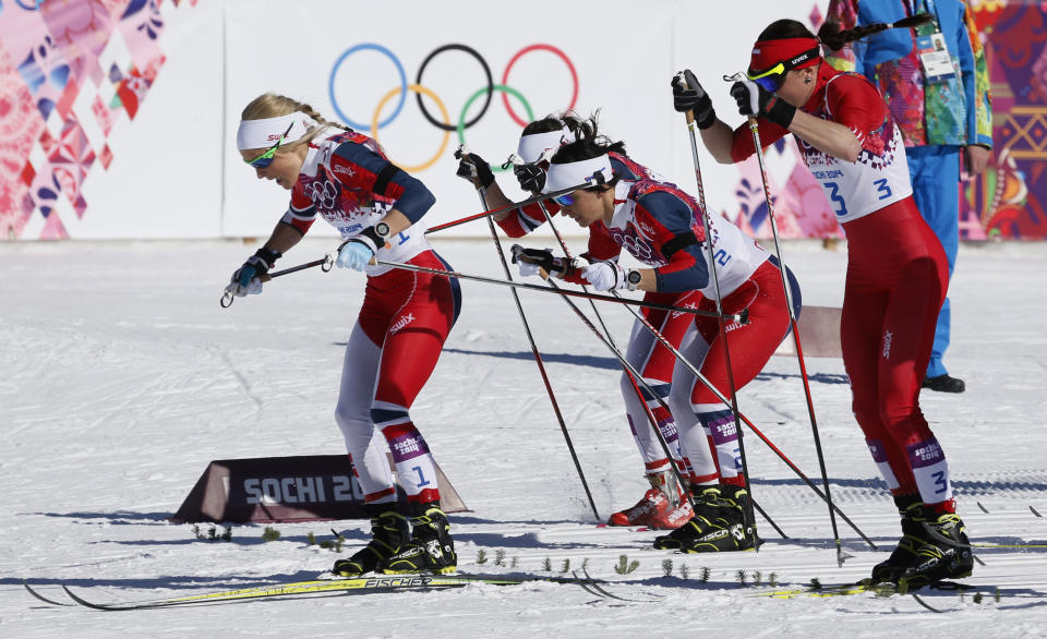 Norway's Therese Johaug, Norway's Marit Bjoergen and Poland's Justyna Kowalczyk, from left, start the women's 15k skiathlon at the 2014 Winter Olympics, Saturday, Feb. 8, 2014, in Krasnaya Polyana, Russia. (AP Photo/Dmitry Lovetsky)