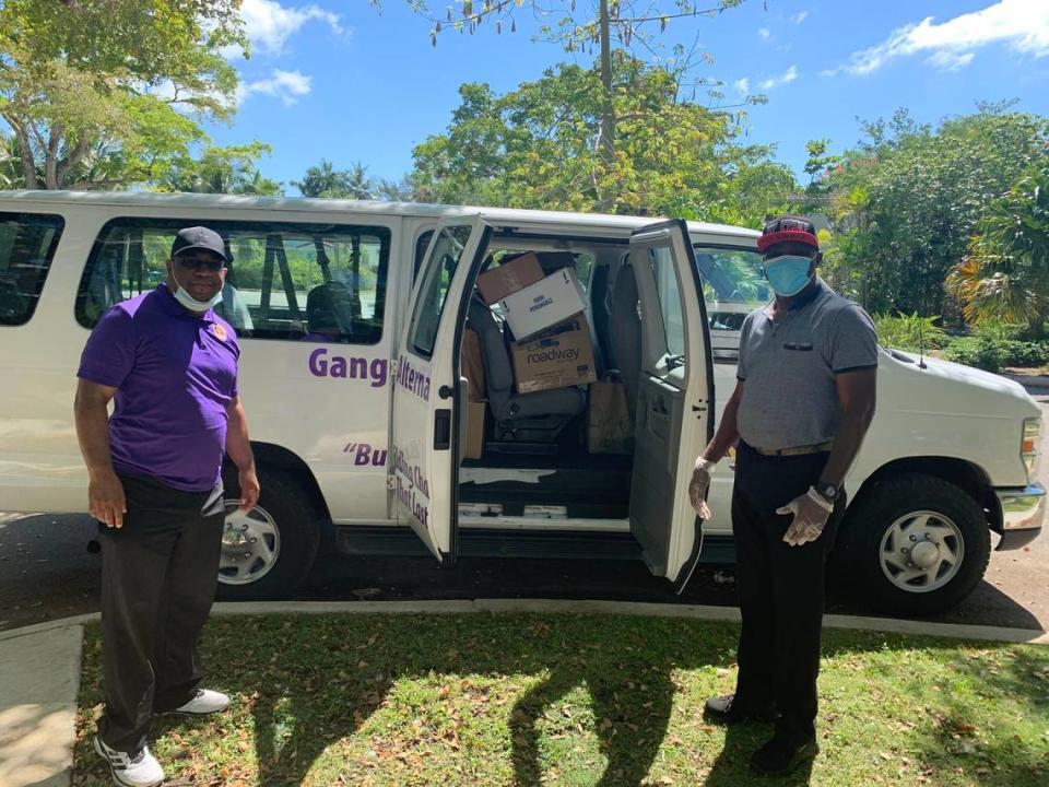 Jose A. Gonzalez and Willy Saint-Hilaire with Gang Alternative, Inc. help deliver food donated by residents of Morningside to help families in Little Haiti.
