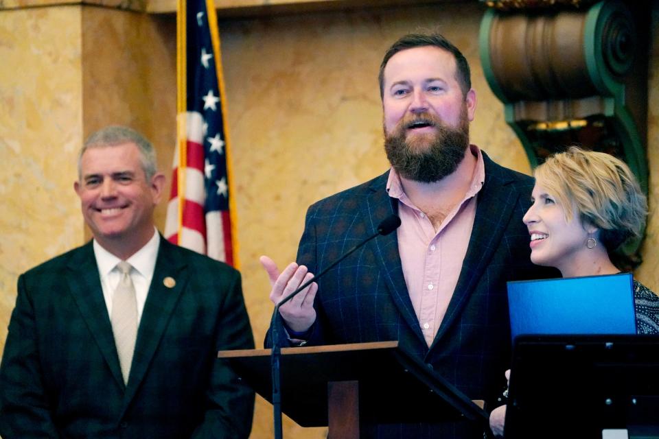 Mississippi House Speaker Philip Gunn, R-Clinton, left, laughs as "Home Town" hosts Ben Napier and Erin Napier, thank lawmakers for a House resolution honoring their HGTV home remodeling show and their work at promoting tourism in their home town of Laurel and the state, while at the Mississippi Capitol in Jackson, Tuesday, March 8, 2022.