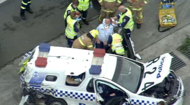 Two officers believed injured in collision involving police car and truck. Photo: 7News