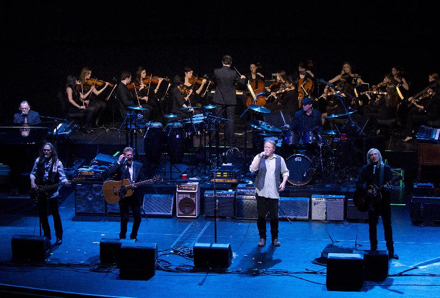 This image released by New York University shows the NYU Steinhardt orchestral string ensemble performing with members of the Eagles, foreground from left, Timothy B. Schmit, Glenn Frey, Don Henley and Joe Walsh at the Inaugural Vision Award Gala, Thursday, Nov. 15, 2012 in New York. (AP Photo/New York University, Mathieu Asselin)