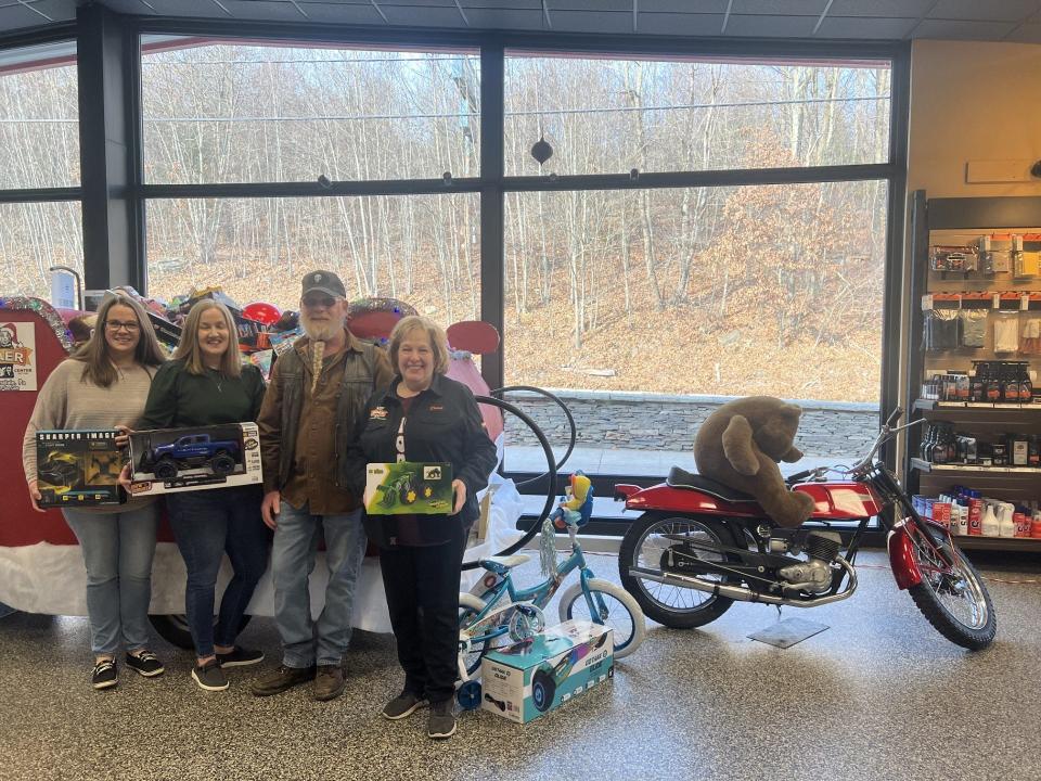 From left at Baer Sport Center, Honesdale, are Mandy Altemier and Sarah Hopkins from the Wayne County Office of Behavioral and Developmental Program and Early Intervention accepting the toys from the annual Fill The Sleigh Motorcycle Run; Damian Gregg the ride organizer; and Diane Helferich, HHR/HOG treasurer.