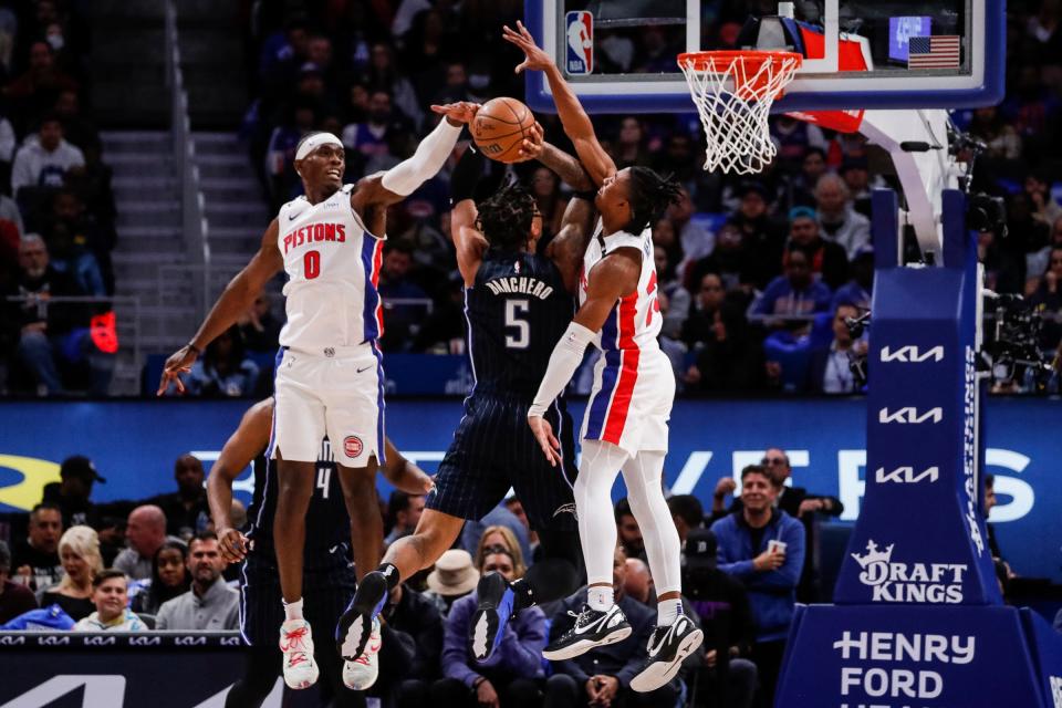 Detroit Pistons center Jalen Duren (0) and guard Jaden Ivey (23) blocks a jump shot by Orlando Magic forward Paolo Banchero (5) during the first half of the season opener at Little Caesars Arena in Detroit on Wednesday, Oct. 19, 2022.