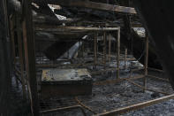 A dormitory destroyed by fire is seen inside the Lhubiriha Secondary School following Saturday's attack on the school in Mpondwe, Uganda Sunday, June 18, 2023, near the border with Congo. Ugandan authorities have recovered the bodies of 41 people including 38 students who were burned, shot or hacked to death after suspected rebels attacked the school, according to the local mayor. (AP Photo/Hajarah Nalwadda)