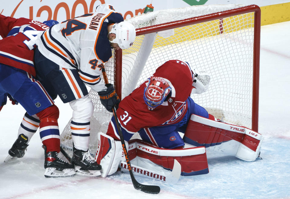Montreal Canadiens goaltender Carey Price blocks the puck from Edmonton Oilers' Zack Kassian during the second period of an NHL hockey game, Tuesday, March 30, 2021 in Montreal. (Paul Chiasson/The Canadian Press via AP)