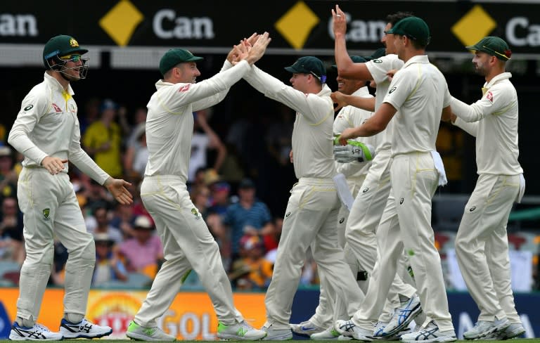 Australia's Mitchell Marsh (2nd L) celebrates with teammates after taking a successful catch to dismiss England's batsman Dawid Malan on the second day of their first Ashes Test match, in Brisbane, on November 24, 2017