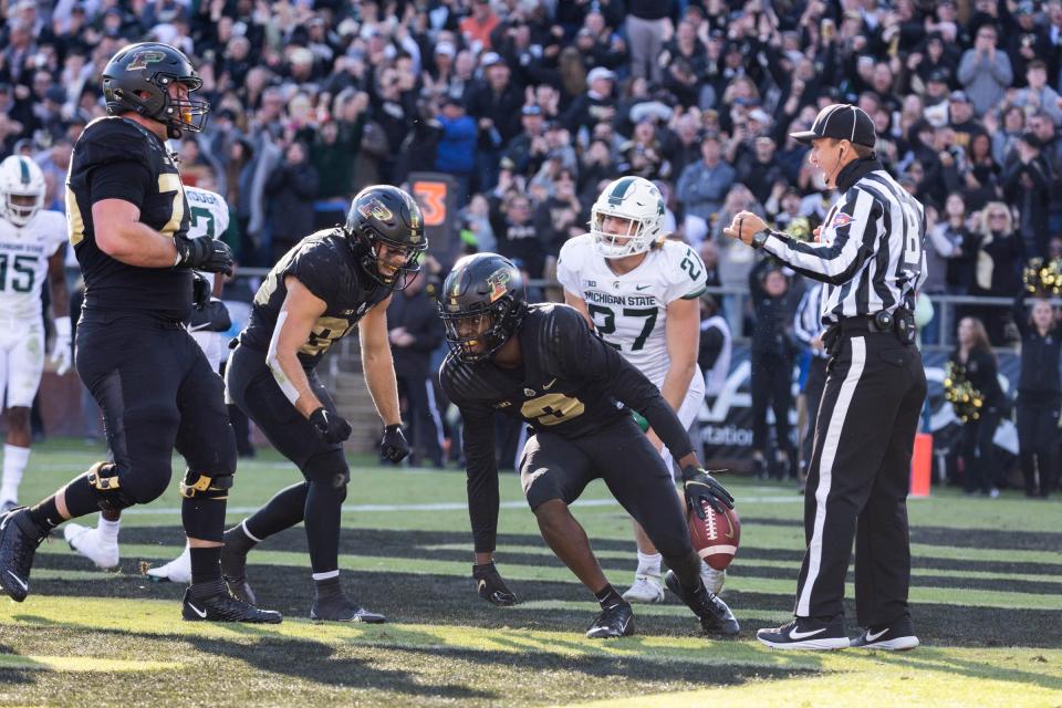 Purdue Boilermakers wide receiver David Bell (3) catches a touchdown while Michigan State Spartans linebacker Cal Haladay (27) defends  in the first quarter at Ross-Ade Stadium on Nov. 6, 2021.