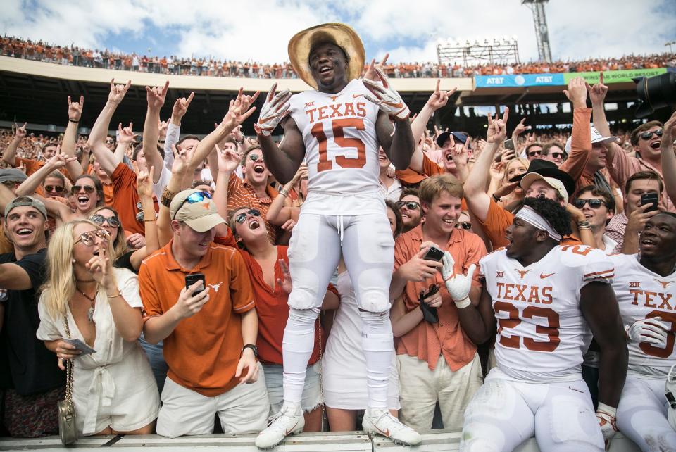 Texas Longhorns defensive back Chris Brown (15) celebrates with fans as he sports the Golden Hat during an NCAA college football game at the Cotton Bowl Stadium in Dallas Texas on Saturday, Oct. 6, 2018. Texas Longhorns beat Oklahoma Sooners 48-45  [RICARDO B. BRAZZIELL/AMERICAN-STATESMAN]