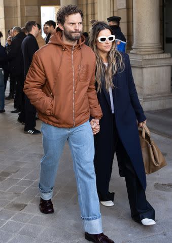 <p>Arnold Jerocki/Getty </p> Jamie Dornan and Amelia Warner attends the Loewe Menswear Fall/Winter 2024-2025 show as part of Paris Fashion Week on January 20, 2024.