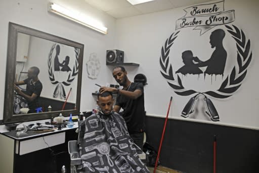 Israeli Ethiopian Jewish hairdresser Baruch works at his barbershop in the southern Israeli city of Ashkelon. Israel's 140,000-strong Ethiopian-Israeli community could prove pivotal in the Jewish state's tight March 2 election