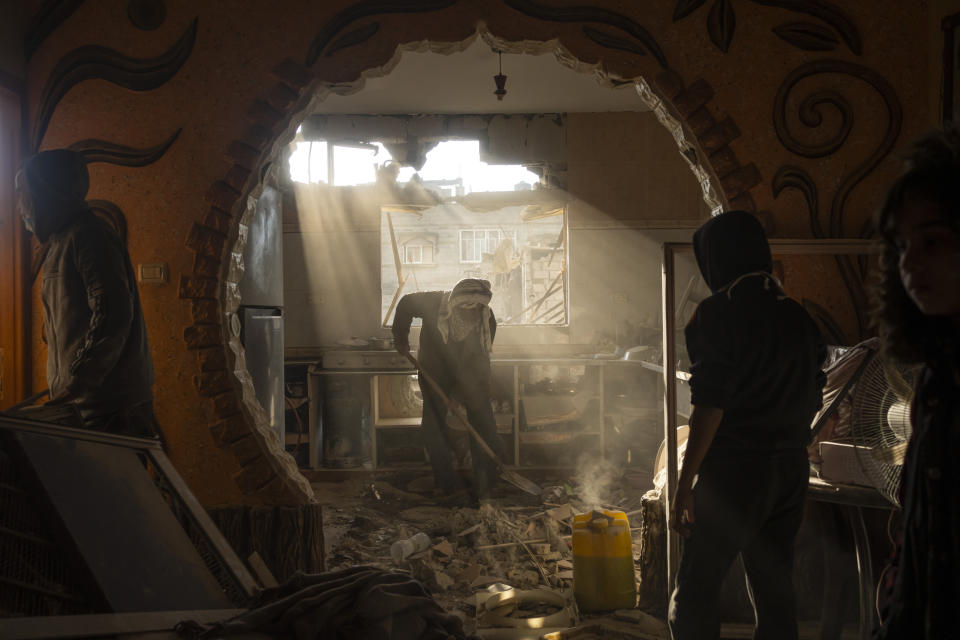 Palestinians look at their neighbour's damaged house following an Israeli strike in Rafah, southern Gaza Strip, Saturday, Jan. 27, 2024. (AP Photo/Fatima Shbair)