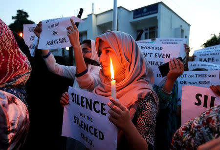 FILE PHOTO: Students participate in a candle light procession as they protest against the rape and murder of an eight-year-old girl in Kathua, in Jammu, April 13, 2018. REUTERS/Mukesh Gupta