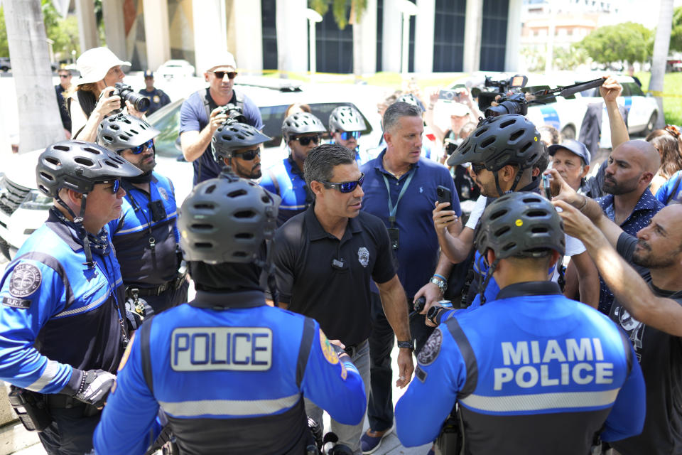 Miami Mayor Francis Suarez greets police outside the Wilkie D. Ferguson Jr. U.S. Courthouse, Tuesday, June 13, 2023, in Miami. Former President Donald Trump is making a federal court appearance on dozens of felony charges accusing him of illegally hoarding classified documents and thwarting the Justice Department's efforts to get the records back. (AP Photo/Rebecca Blackwell)