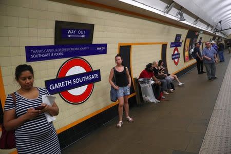 Passengers wait at Southgate Underground Station, temporarily renamed as 'Gareth Southgate' in honour of England soccer team manager Gareth Southgate, in London, Britain July 16, 2018. REUTERS/Hannah McKay