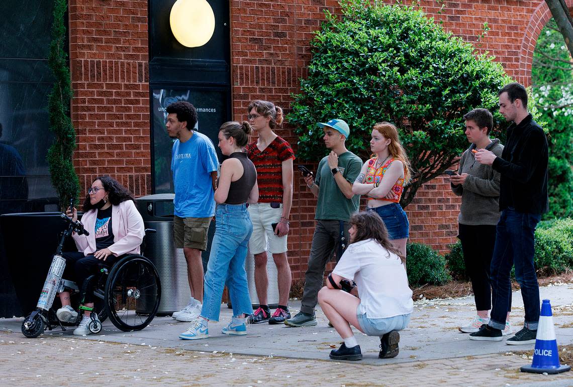 A group of students from UNC-Chapel Hill wait outside of the Alex Ewing Performance Place building on the campus of UNC School of the Arts after a meeting of the UNC System Board of Governors’ University Governance committee went into closed session on Wednesday, April 17, 2024, in Winston-Salem, N.C.