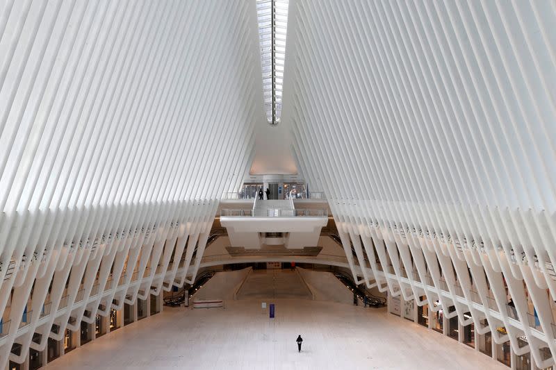 FILE PHOTO: Man walks alone through Oculus transportation hub during outbreak of the coronavirus disease (COVID-19) in New York