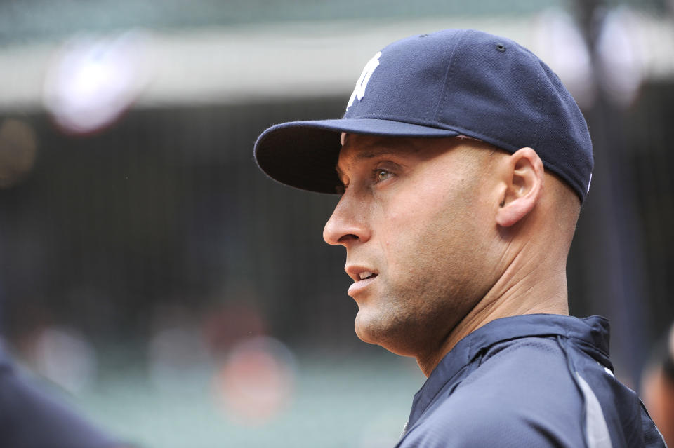 New York Yankees' Derek Jeter looks out to the field before a baseball game against the Houston Astros on opening day Tuesday, April 1, 2014, in Houston. (AP Photo/Pat Sullivan)