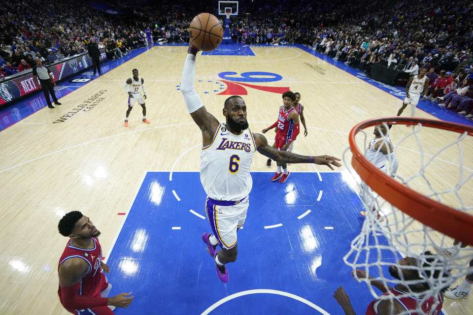 FILE - Los Angeles Lakers' LeBron James goes up for a dunk during the first half of an NBA basketball game against the Philadelphia 76ers, Friday, Dec. 9, 2022, in Philadelphia. Lakers coach Darvin Ham, in an essay for The Associated Press, says James' work ethic is beyond compare. James is about to pass Kareem Abdul-Jabbar for the NBA career scoring record. (AP Photo/Matt Slocum, File)