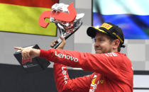 Ferrari driver Sebastian Vettel of Germany celebrates on the podium after he placed second in the German Formula One Grand Prix at the Hockenheimring racetrack in Hockenheim, Germany, Sunday, July 28, 2019. (AP Photo/Jens Meyer)