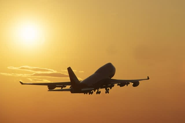 boeing 747s jumbo jet taking off at sunset