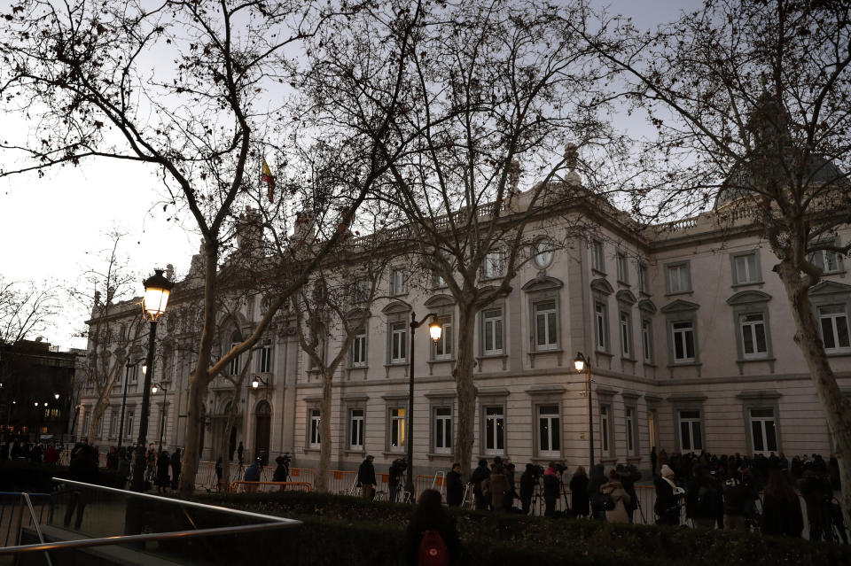 Journalists wait outside the Spanish Supreme Court in Madrid, Tuesday, Feb. 12, 2019. Spain is bracing for the nation's most sensitive trial in four decades of democracy this week, with a dozen Catalan separatists facing charges including rebellion over a failed secession bid in 2017. (AP Photo/Manu Fernandez)