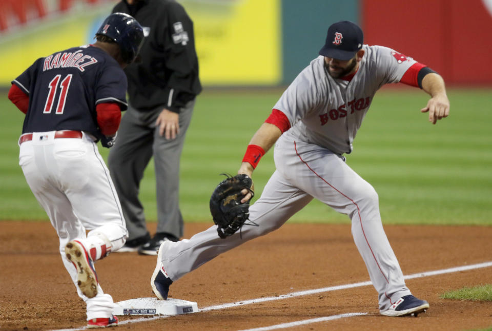 Boston Red Sox first baseman Mitch Moreland, right, stretches to get Cleveland Indians' Jose Ramirez out in the first inning of a baseball game, Sunday, Sept. 23, 2018, in Cleveland. (AP Photo/Tom E. Puskar)