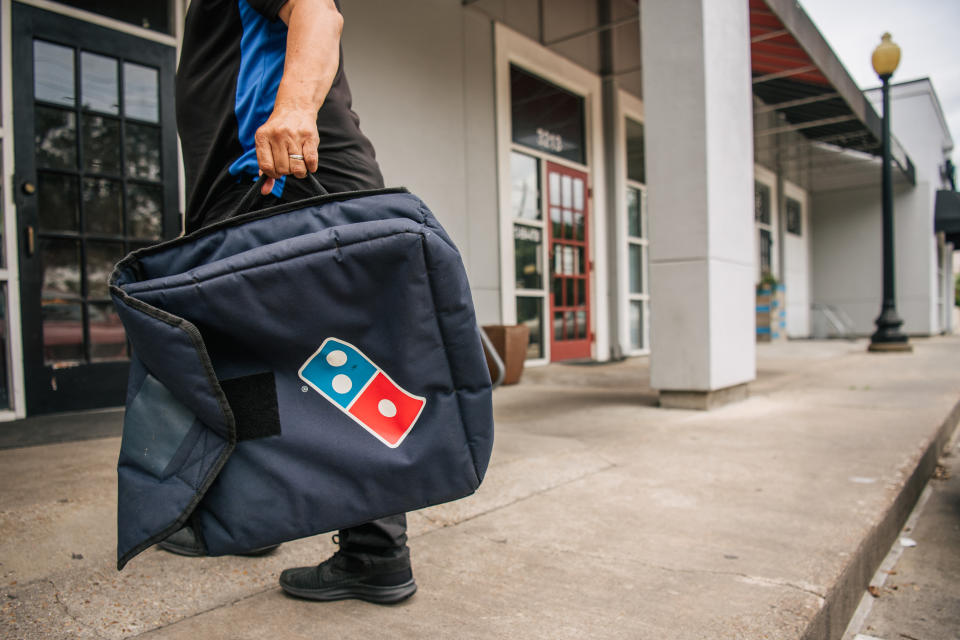 HOUSTON, TEXAS - JULY 22: A Domino's Pizza employee returns from a delivery on July 22, 2021 in Houston, Texas. Domino's pizza has reported that its U.S. same-store sales have increased by 3.5% in its latest quarter of production. CEO Ritch Allison has said that the company will raise wages for employees, in certain markets and positions, at corporate-owned restaurants. Allison also noted that a lack of staffing and equipment shortages have been major hurdles as the company continues to deal with problems tied to the pandemic. (Photo by Brandon Bell/Getty Images)