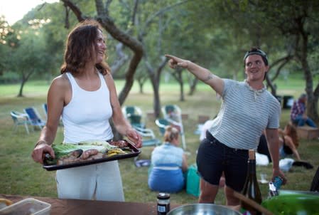 Layton Guenther gathers with other farmers for a potluck dinner and music in Amagansett