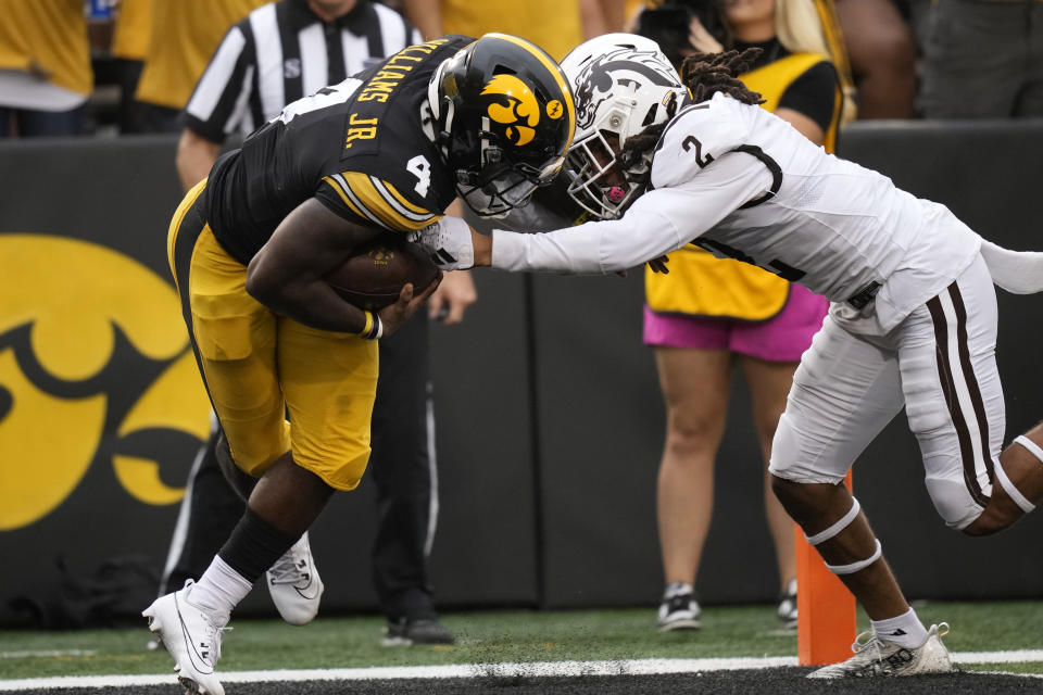 Iowa running back Leshon Williams (4) scores on a 25-yard touchdown reception in front of Western Michigan cornerback Keni-H Lovely (2) during the first half of an NCAA college football game, Saturday, Sept. 16, 2023, in Iowa City, Iowa. (AP Photo/Charlie Neibergall)