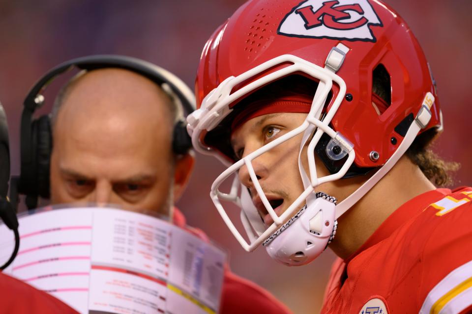 Kansas City Chiefs quarterback Patrick Mahomes talks to Chiefs head coach Andy Reid, out of frame left, as Chiefs offensive coordinator Matt Nagy listens in, center, during the first half of an NFL football game against the Buffalo Bills, Sunday, Dec. 10, 2023 in Kansas City, Mo.