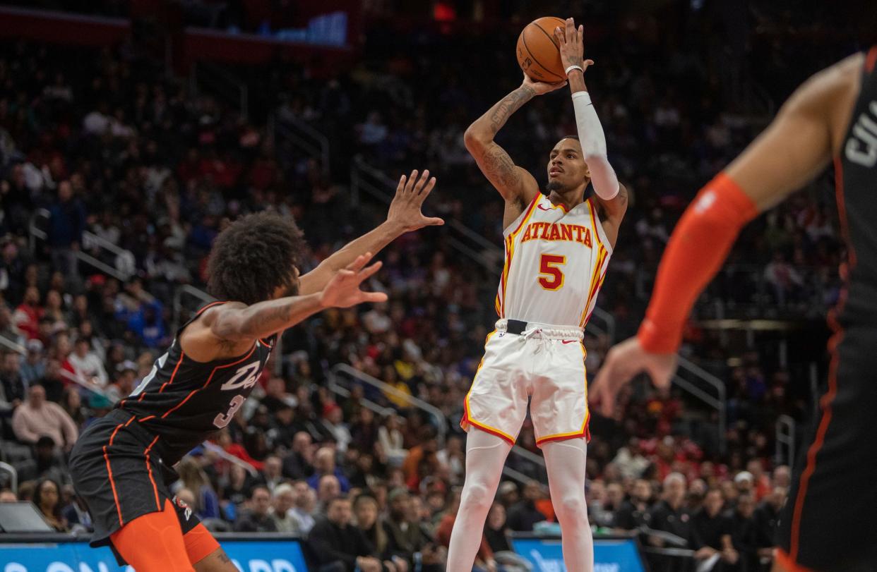 Hawks guard Dejounte Murray goes for a shot against Pistons center Marvin Bagley III during the second half of the game at the Little Caesars Arena in Detroit on Tuesday, Nov. 14, 2023.