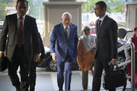 Former Malaysian Prime Minister Najib Razak, center, arrives at Kuala Lumpur High Court in Kuala Lumpur, Malaysia, Tuesday, Aug. 27, 2019. Malaysian prosecutors have wrapped up their case against Najib in his first corruption trial. Najib faces 42 charges of corruption, abuse of power and money laundering in five criminal cases linked to the multibillion-dollar looting of the 1MDB state investment fund. His second trial is due to begin Wednesday but could be delayed. Najib denies wrongdoing and accuses the new government of seeking political vengeance. (AP Photo/Vincent Thian)