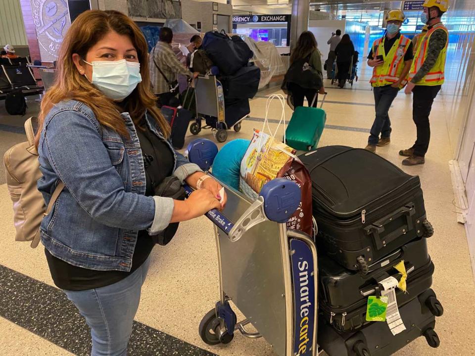 Norma Ramirez with luggage and fried chicken.