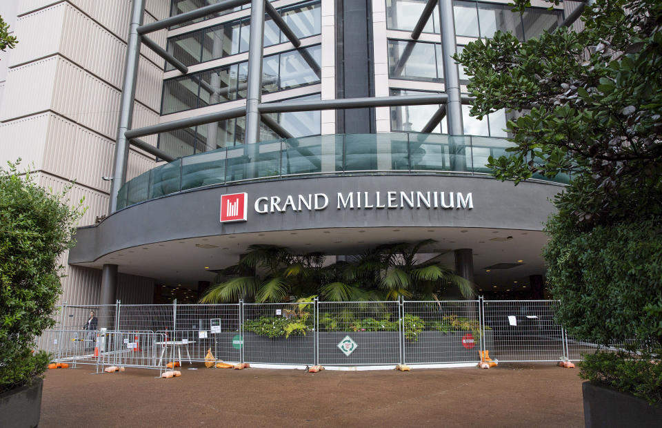 The Grand Millennium hotel, a managed isolation facility, is seen in central Auckland, New Zealand, July, 16, 2020. A traveler and a worker at the quarantine hotel started passing each other notes, including one written on the back of a face mask. Then he delivered a bottle of wine she'd ordered to her room. When he didn't return 20 minutes later, a security manager sent to investigate found the pair together in what authorities are describing as an inappropriate encounter, one in which physical distancing wasn't maintained. (Sylvie Whinray/New Zealand Herald via AP)