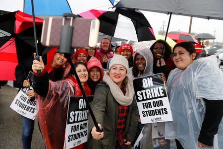 FILE PHOTO: Los Angels public school teachers continue to deal with the rainy weather as their strike enters its third day in Gardena, California, U.S., January 16, 2019.REUTERS/Mike Blake