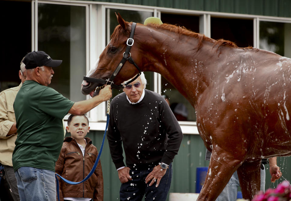 Trainer Bob Baffert, right, watches as Triple Crown hopeful Justify is bathed after a workout at Belmont Park on Thursday. (AP)