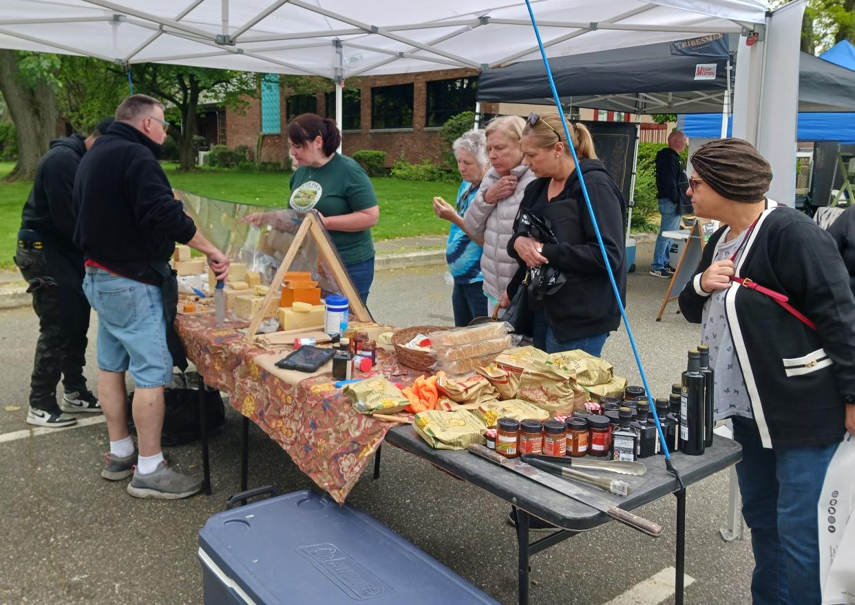 Pictured are patrons browsing through the Little Falls Farmers Market during its opening celebration.